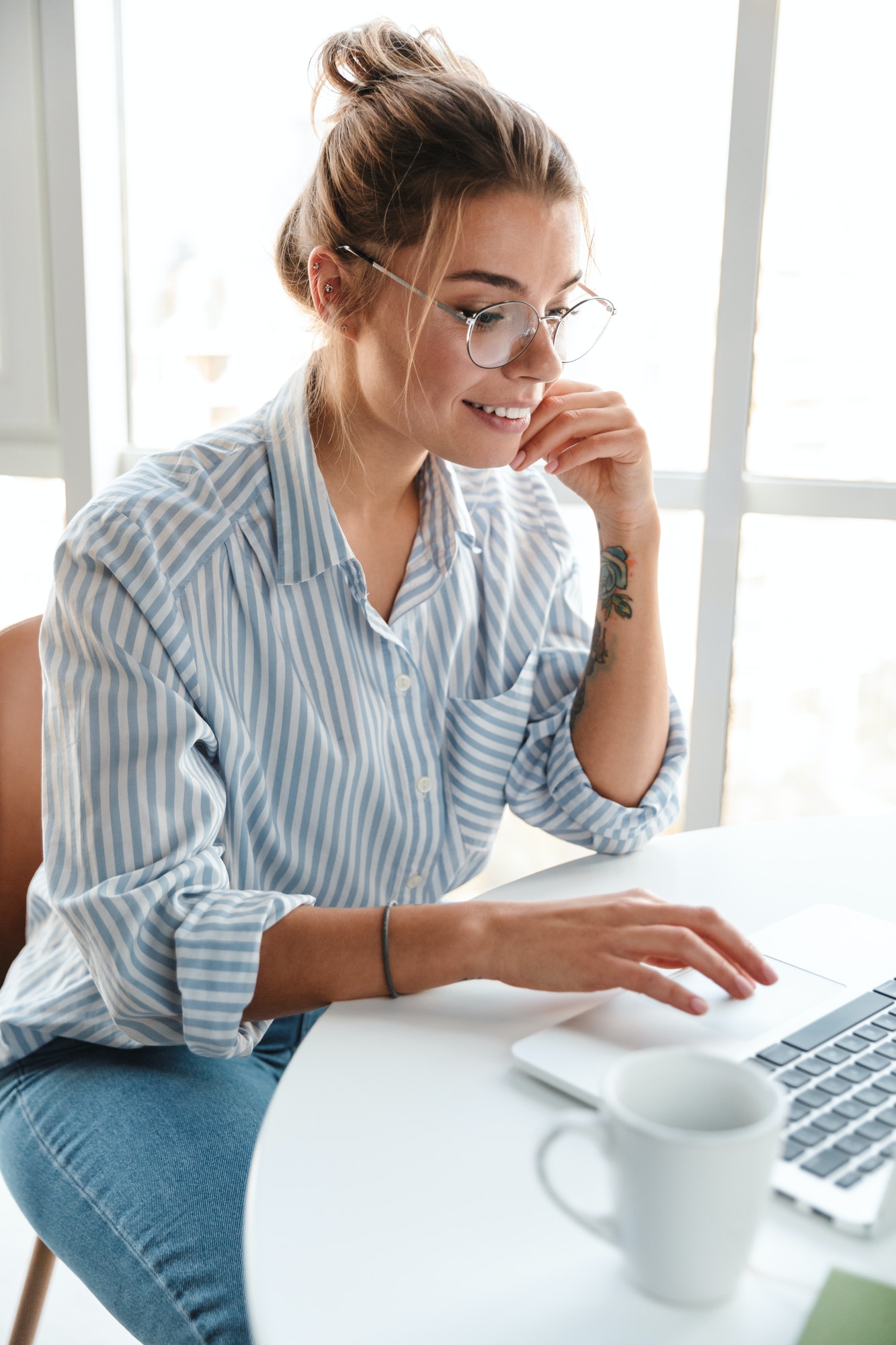 Smiling young woman on laptop